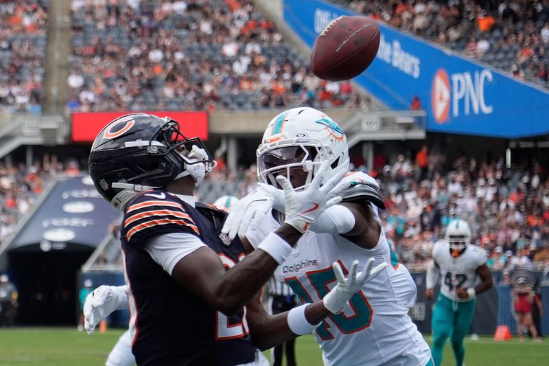 Aug 10, 2025; Chicago, Illinois, USA; Chicago Bears wide receiver Jahdae Walker (20) catches a touchdown pass as Miami Dolphins linebacker Jaelan Phillips (15) defends him during the second half at Soldier Field. Mandatory Credit: David Banks-Imagn Images