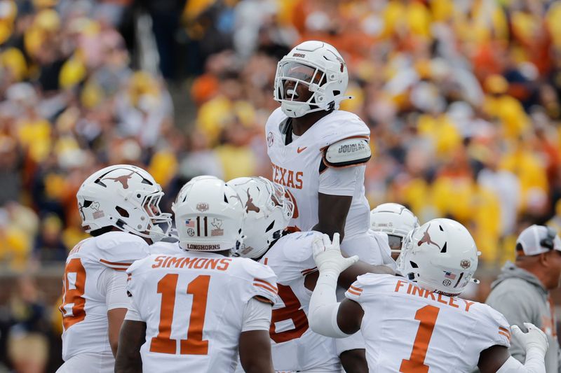 Sep 7, 2024; Ann Arbor, Michigan, USA; Texas Longhorns defensive back Derek Williams Jr. (2) celebrates with teammates after making an interception in the second half am at Michigan Stadium. Mandatory Credit: Rick Osentoski-Imagn Images