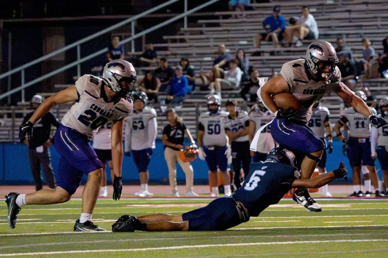 Franklin’s Ernie Powers (4) jumps as he’s about to be stopped by Chapin’s Juju Foster (5) following a lightning delay in the season opener on Thursday, Aug. 28, 2025, at Irvin High School in El Paso, Texas.