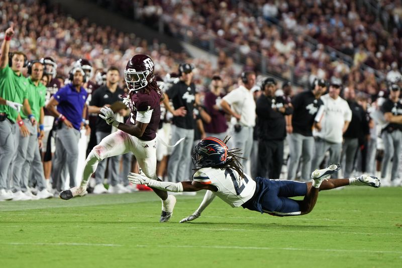 Aug 30, 2025; College Station, Texas, USA; Texas A&M Aggies wide receiver Mario Craver (1) escapes a tackle from UTSA Roadrunners safety Brandon Jacob Jr. (21) in the second half against the UTSA Roadrunners at Kyle Field. Mandatory Credit: Sean Thomas-Imagn Images