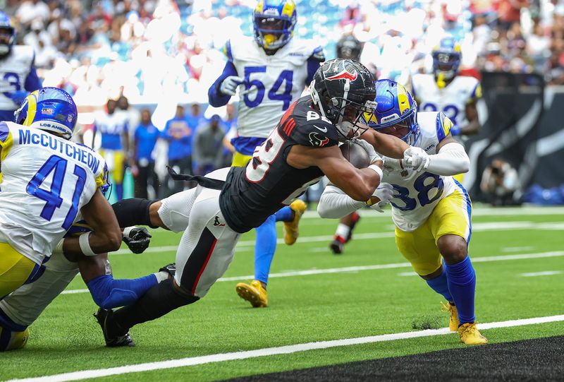 Aug 24, 2024; Houston, Texas, USA; Houston Texans wide receiver Johnny Johnson III (88) extends past Los Angeles Rams cornerback Shaun Jolly (38) to score a touchdown during the fourth quarter at NRG Stadium. Mandatory Credit: Troy Taormina-USA TODAY Sports