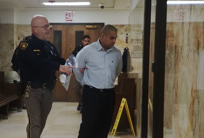 Adam Canales Jr. is escorted Tuesday out of the 137th District Court where he was sentenced to 20 years in prison after he was found guilty of recklessly caused the death of his 2-month-old daughter by giving her lethal doses of anti-allergy medication four years ago.