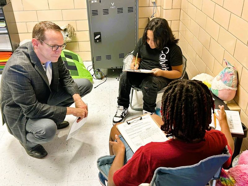 Texas Education Agency Commissioner Mike Morath visits with students Wednesday in teacher Armetha Blackmon's fifth grade class at Booker T. Washington Elementary School. Morath was gathering information in Wichita Falls ISD ahead of making a decision about the district's fate.