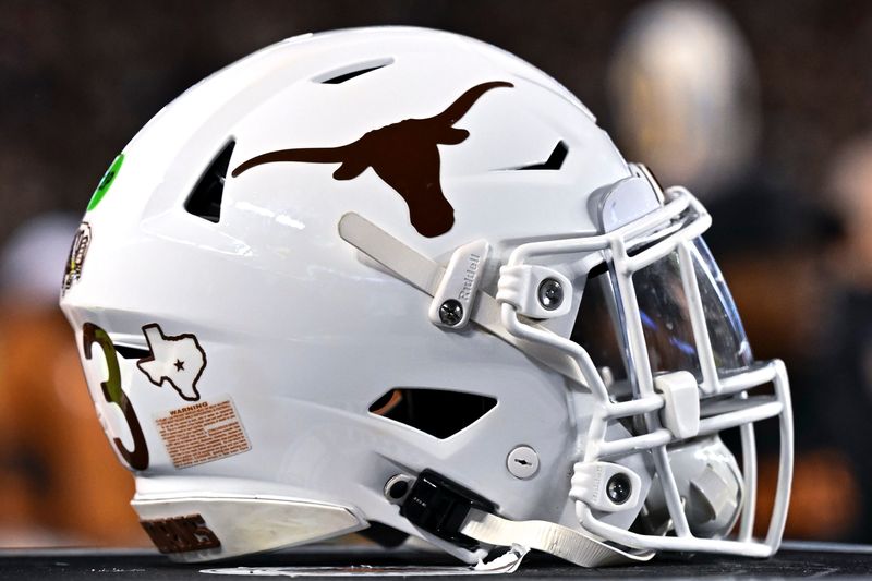 Nov 30, 2024; College Station, Texas, USA; A detail view of a Texas Longhorns helmet on the sideline during the first quarter against the Texas A&M Aggies. The Longhorns defeated the Aggies 17-7 at Kyle Field. Mandatory Credit: Maria Lysaker-Imagn Images