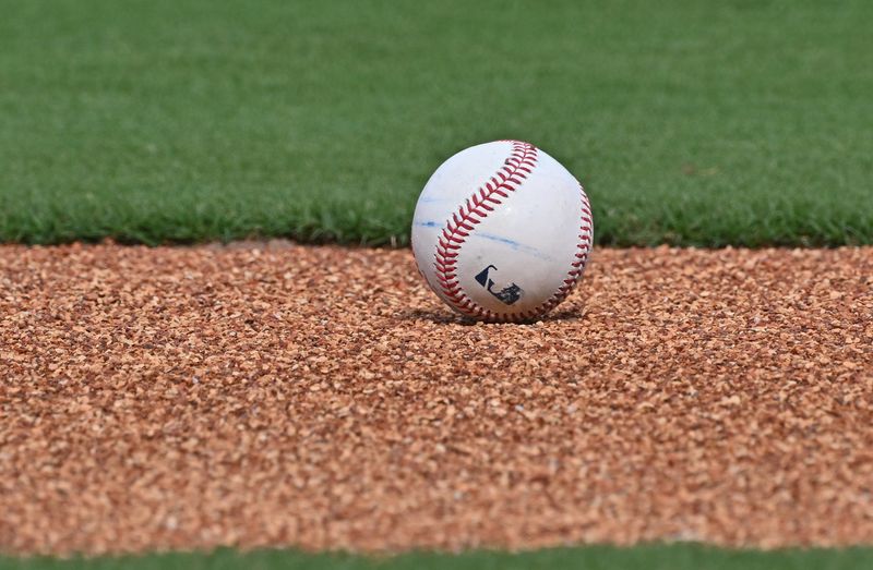 Aug 19, 2025; Kansas City, Missouri, USA; A baseball lays on the field during batting practice before a game between the Kansas City Royals and Texas Rangers at Kauffman Stadium. Mandatory Credit: Peter Aiken-Imagn Images