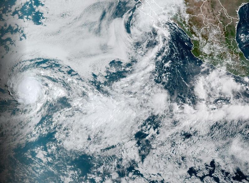 Hurricane Kiko and Tropical Storm Lorena seen together in the eastern Pacific Ocean on the morning of Sept. 4, with Kiko on the left where the sun is still rising, and Lorena in the upper right.
