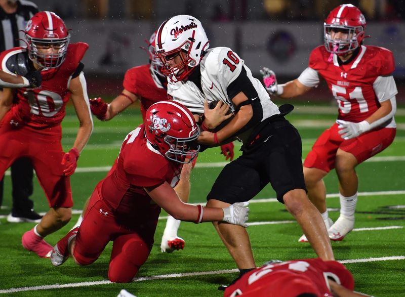Holliday's defense tackles Muenster's Legend Bounds during a game on Friday, Sep. 5, 2025 in Holliday.