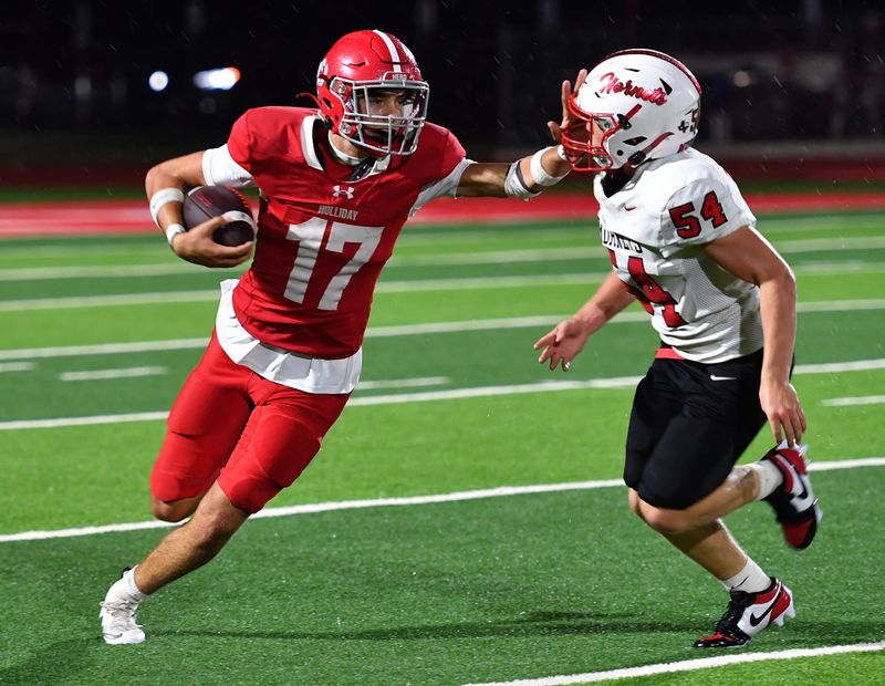 Holliday's Landon Jones stiff-arms Muenster's Brady Klement during a game on Friday, Sep. 5, 2025 in Holliday.