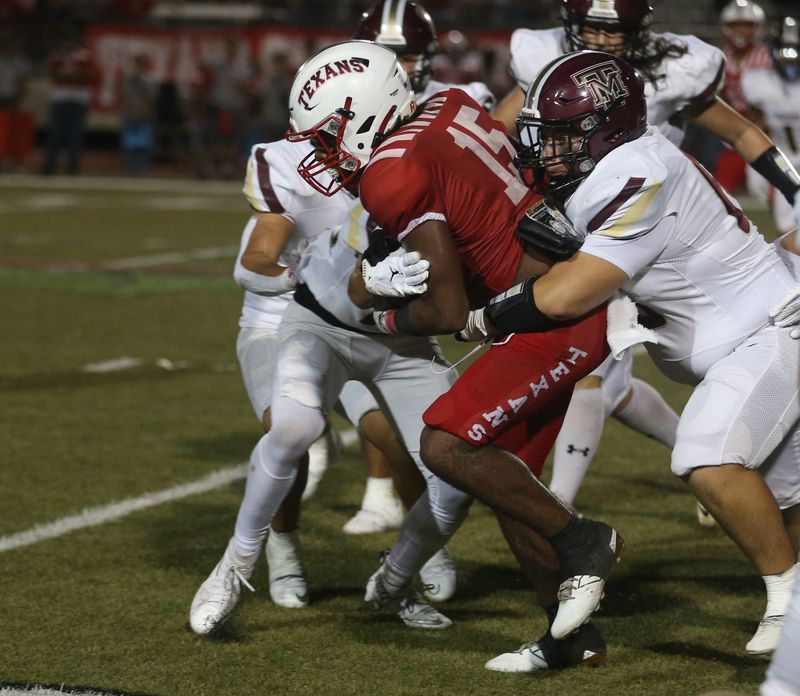 Ray running back Brian McCullum fights through several Tuloso-Midway defenders during a non-district high school football game at Buccaneer Stadium, Friday, Sept. 5, 2025.
