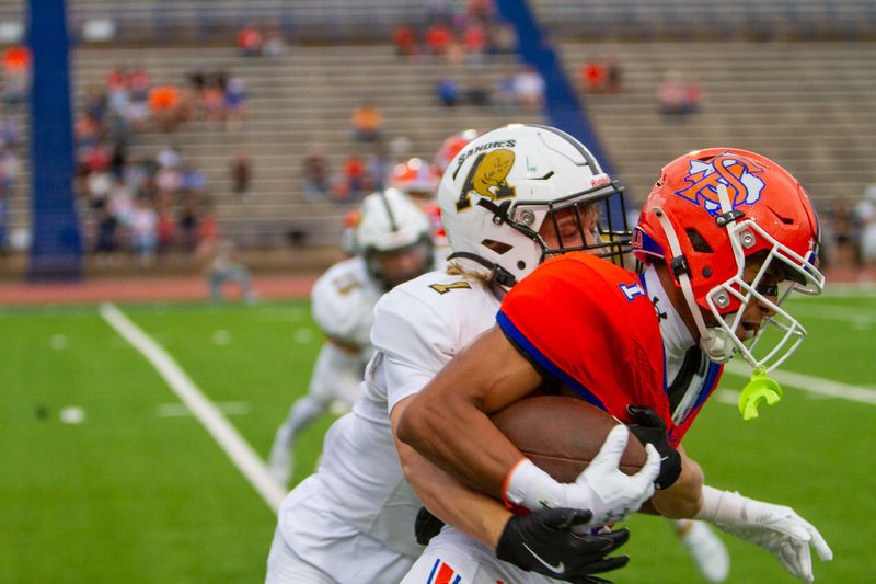 Amarillo High football's Creed Cavalier (1) attempts to tackle San Angelo Central football's Gabriel Garcia (1) in a matchup at San Angelo Stadium on Friday, Sept. 5, 2025.