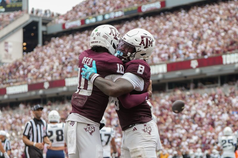 Sep 6, 2025; College Station, Texas, USA; Texas A&M Aggies quarterback Marcel Reed (10) and Texas A&M Aggies running back Le'Veon Moss (8) celebrate after a touchdown during the second quarter against the Utah State Aggies at Kyle Field. Mandatory Credit: Sean Thomas-Imagn Images