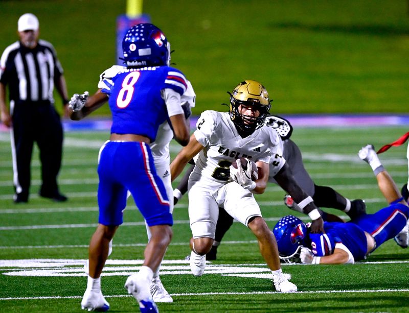 Eagles running back Ethan Joyner sidesteps Cooper High defenders during the Crosstown Showdown football game between Abilene High and the Cougars Friday Sept. 5, 2025. Final score was 34-13, Abilene High.