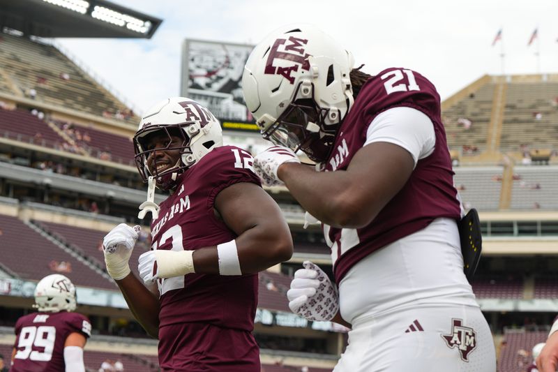 Sep 6, 2025; College Station, Texas, USA; Texas A&M Aggies defensive end Nana Boadi-Owusu (12) and Texas A&M Aggies tight end Kiotti Armstrong (21) dancing during pregame against the Utah State Aggies at Kyle Field. Mandatory Credit: Sean Thomas-Imagn Images