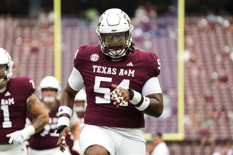 Sep 6, 2025; College Station, Texas, USA; Texas A&M Aggies offensive lineman Mark Nabou Jr. (54) warming up during pregame against the Utah State Aggies at Kyle Field. Mandatory Credit: Sean Thomas-Imagn Images