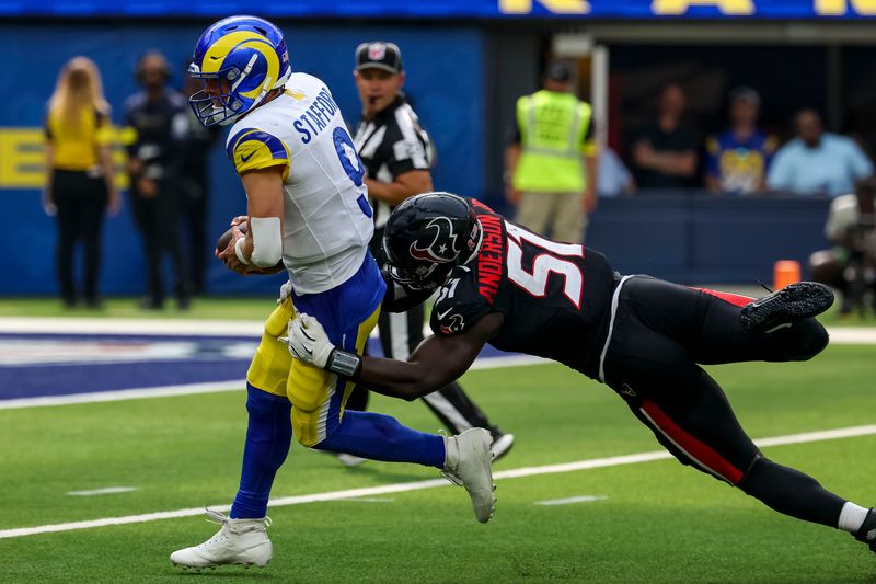 Sep 7, 2025; Inglewood, California, USA; Los Angeles Rams quarterback Matthew Stafford (9) is sacked by Houston Texans defensive end Will Anderson Jr. (51) during the second quarter at SoFi Stadium. Mandatory Credit: Kiyoshi Mio-Imagn Images