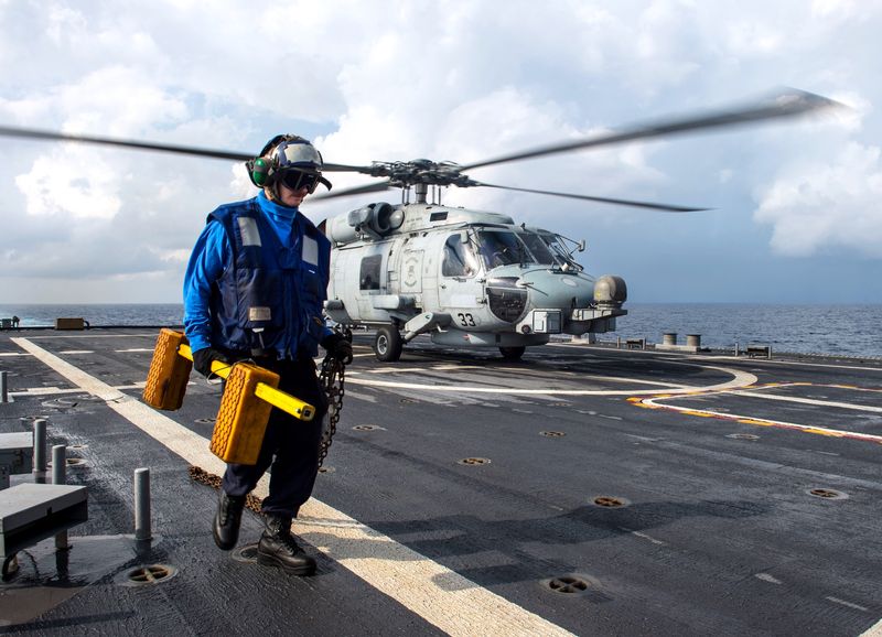 Logistics Specialist 2nd Class Victor O’Leary pulls the chalk and chains for an MH-60R Seahawk helicopter, from Helicopter Maritime Strike Squadron (HSM-35), on the flight deck aboard USS Fort Worth (LCS 3) during operations in the South China Sea Dec. 14, 2015. The vessel was on a rotational deployment in support of the Asia-Pacific Rebalance, Fort Worth is one of the Navy’s latest warships and is designed to operate within a region’s littoral or shallow areas approaching the shore.