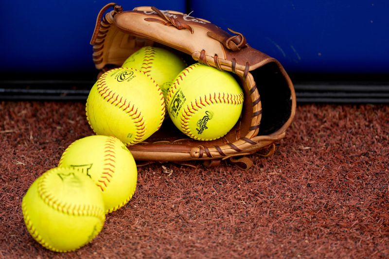 A softball glove with softballs is pictured before Game 1 of the Women's College World Series championship series between the Texas Longhorns at Texas Tech Red Raiders at Devon Park in Oklahoma City, Wednesday, June 4, 2025. Texas won 2-1.