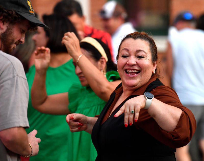 Dancers twirl and raise their hands during Latin Dance Night at the Grace Museum Thursday. The evening heralded Hispanic Heritage Month, which starts Monday.