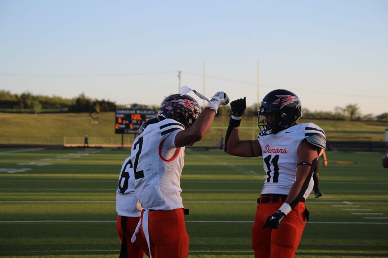 Dumas' L.D. Balbuena and Chris Jimenez celebrate after Balbuena caught a touchdown during a non-district football game against Canadian at Wildcat Stadium on Sept. 12, 2025.