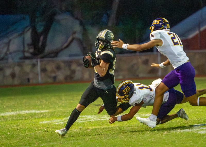 Brady football's Ashton Taylor (32) runs the ball as Ozona's Leo Blanco (21) and Nolan Martinez (11) close in for a tackle at Bulldog Stadium in Brady, Texas on Friday, Sept. 12, 2025.