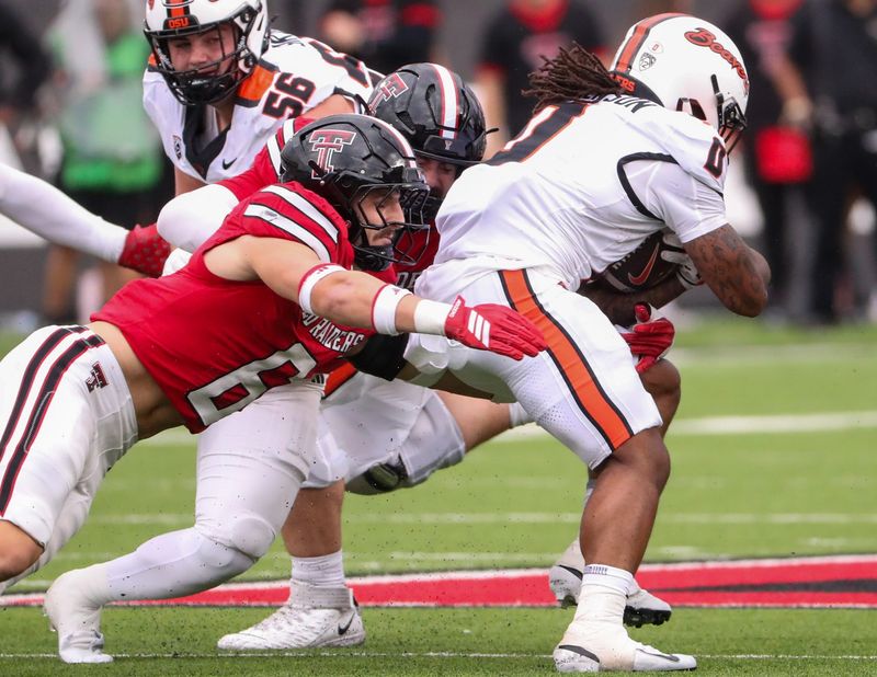 Texas Tech's John Curry and Jacob Rodriguez tackle Oregon State's Anthony Hankerson during a non-conference football game, Saturday, Sept. 13, 2025, at Jones AT&T Stadium.