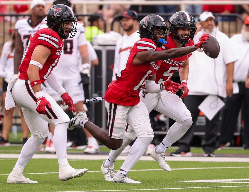 Texas Tech's Brice Pollock (center) celebrates his interception with Cole Wisniewski and Ben Roberts against Oregon State during a non-conference football game, Saturday, Sept. 13, 2025, at Jones AT&T Stadium.