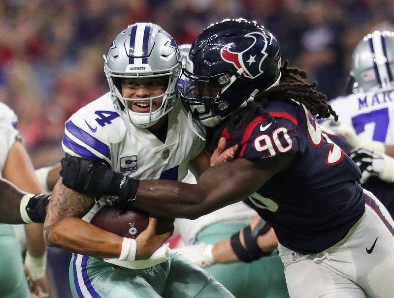 Oct 7, 2018; Houston, TX, USA; Dallas Cowboys quarterback Dak Prescott (4) evades the tackle of Houston Texans linebacker Jadeveon Clowney (90) during the second half at NRG Stadium. Mandatory Credit: Kevin Jairaj-USA TODAY Sports