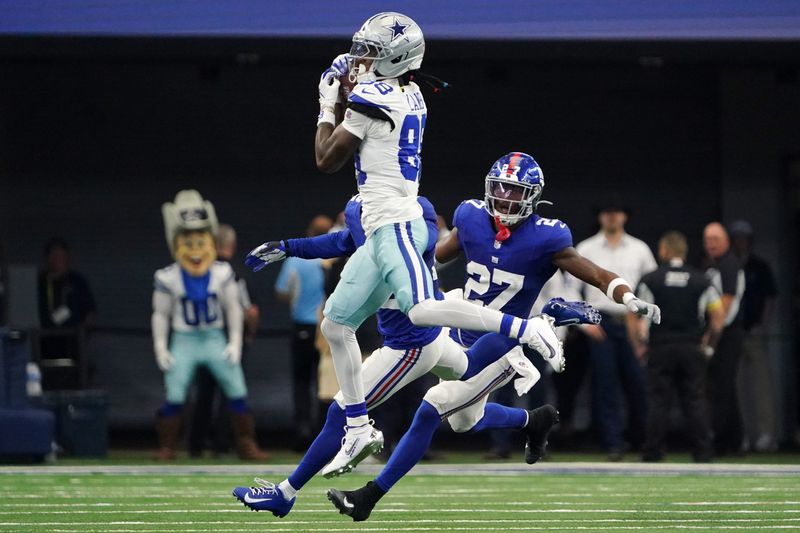 Sep 14, 2025; Arlington, Texas, USA; Dallas Cowboys wide receiver CeeDee Lamb (88) makes a catch against New York Giants safety Tyler Nubin (27) during the fourth quarter at AT&T Stadium. Mandatory Credit: Raymond Carlin III-Imagn Images