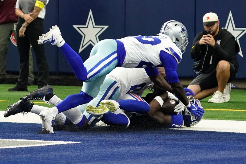 Sep 14, 2025; Arlington, Texas, USA; New York Giants wide receiver Malik Nabers (1) scores a touchdown against the Dallas Cowboys during the fourth quarter at AT&T Stadium. Mandatory Credit: Raymond Carlin III-Imagn Images