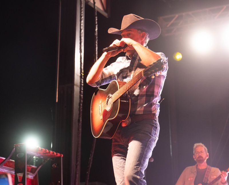 In this September 2025 file photo, Aaron Watson makes a heart gesture to the audience during his headlining set at the Patriot Day Celebration in Bushland, Texas, sharing appreciation with fans between songs.