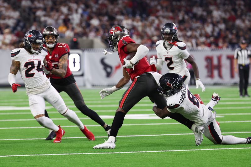 Sep 15, 2025; Houston, Texas, USA; Tampa Bay Buccaneers running back Rachaad White (1) is tackled by Houston Texans safety C.J. Gardner-Johnson (8) during the fourth quarter at NRG Stadium. Mandatory Credit: Thomas Shea-Imagn Images