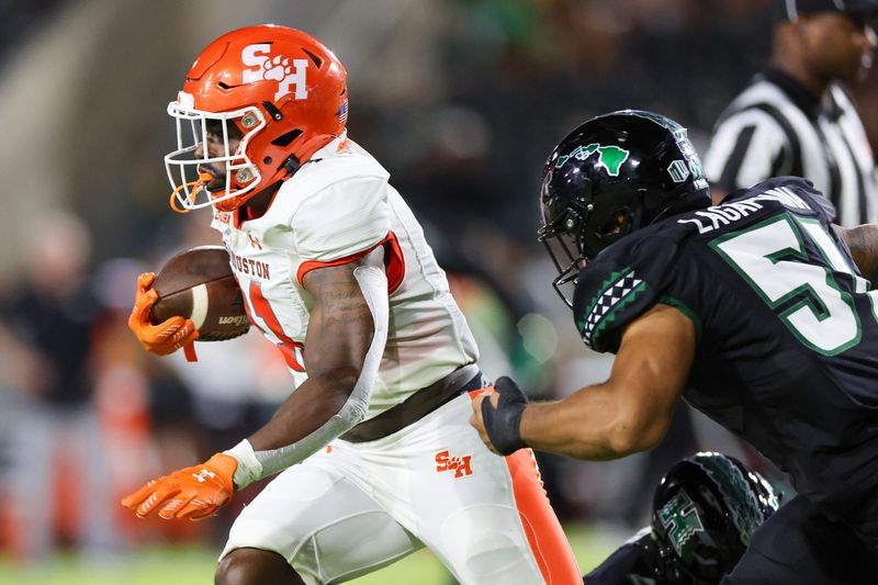 Sep 6, 2025; Honolulu, Hawaii, USA; Sam Houston Bearkats running back Elijah Green (21) is chased down by Hawaii Rainbow Warriors defensive lineman Lesterlaisene Lagafuaina (51) during the second quarter at Clarence T.C. Ching Athletics Complex. Mandatory Credit: Marco Garcia-Imagn Images