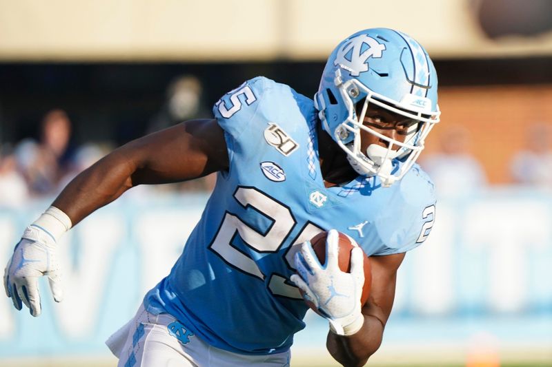 Sep 21, 2019; Chapel Hill, NC, USA; North Carolina Tar Heels running back Javonte Williams (25) runs with the ball during the second half against the Appalachian State Mountaineers at Kenan Memorial Stadium. The Appalachian State Mountaineers defeats the North Carolina Tar Heels 34-31. Mandatory Credit: James Guillory-USA TODAY Sports