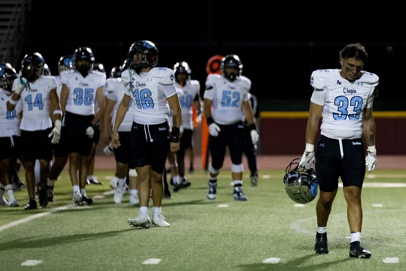 Chapin players walk to the locker room during a lightning delay in a District 1-5A football game against Andress at Andress High in El Paso, Texas, on Friday, Sept. 19, 2025.