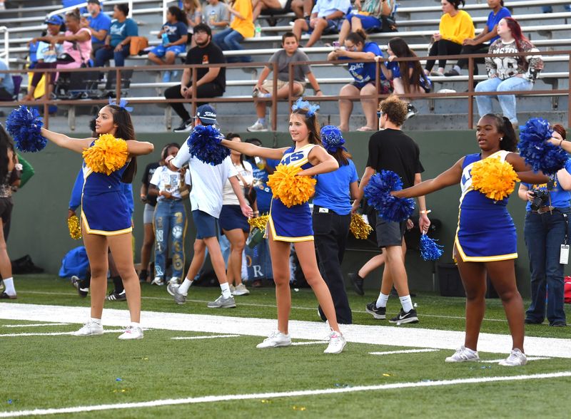 Legacy cheerleaders (left to right) Chloe Smith, Adelle Smith and Jaciee Morales line up on the sideline before the football team runs out on the field. The Legacy Leopards hosted the Canyon Randall Raiders in a non-district matchup Friday at Memorial Stadium.