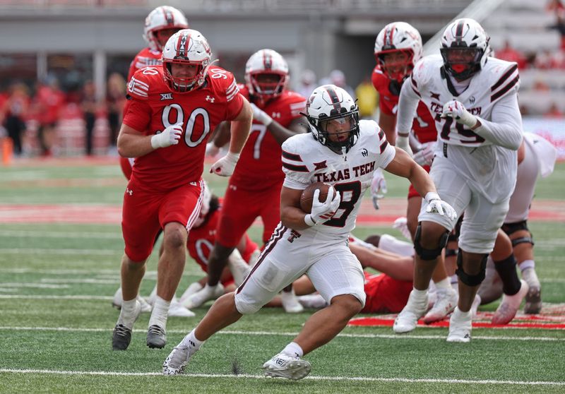 Sep 20, 2025; Salt Lake City, Utah, USA; Texas Tech Red Raiders running back Cameron Dickey (8) runs the ball against Utah Utes defensive end John Henry Daley (90) during the fourth quarter at Rice-Eccles Stadium. Mandatory Credit: Rob Gray-Imagn Images
