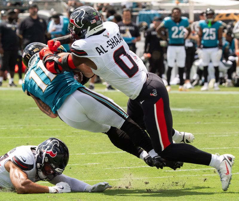 Houston’s Azeez Al-Shaair tackles Jacksonville Jaguars wide receiver Parker Washington (11) during the first quarter between the Houston Texans and the Jacksonville Jaguars Sunday September 21, 2025 at EverBank Stadium in Jacksonville, Fla. [Doug Engle/Florida Times-Union]
