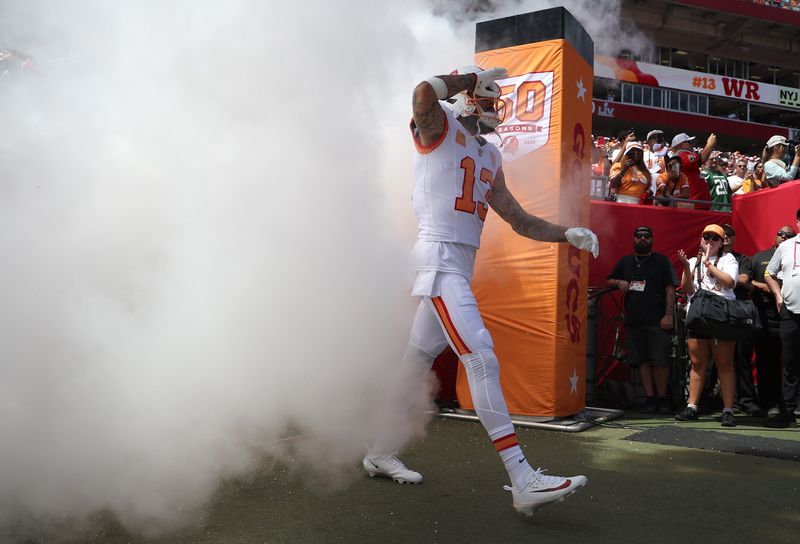 Sep 21, 2025; Tampa, Florida, USA; Tampa Bay Buccaneers wide receiver Mike Evans (13) runs out of the tunnel prior to the game against the New York Jets at Raymond James Stadium. Mandatory Credit: Kim Klement Neitzel-Imagn Images