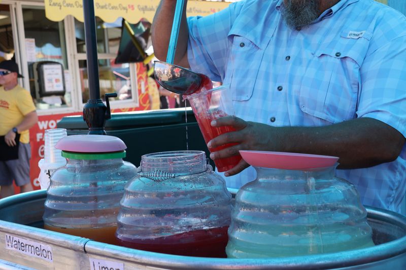 A member of the Wonder Bar food stand pours a watermelon agua fresca at the Panhandle South Plains Fair on Sep. 23, 2025 in Lubbock, Texas.
