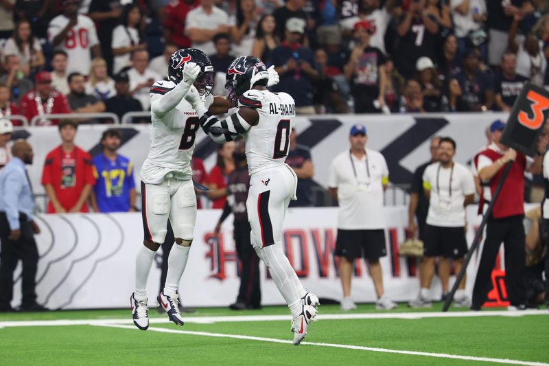 Sep 15, 2025; Houston, Texas, USA; Houston Texans safety C.J. Gardner-Johnson (8) and Houston Texans linebacker Azeez Al-Shaair (0) celebrate after making a tackle during the second quarter against the Tampa Bay Buccaneers at NRG Stadium. Mandatory Credit: Thomas Shea-Imagn Images