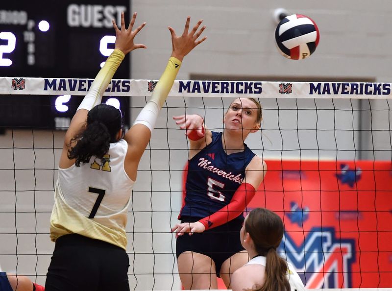 Memorial's Eva Grisel hits the ball over the net during a game against Abilene High on Tuesday, Sep. 23, 2025 at Memorial High School.