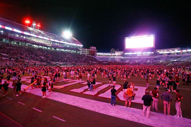 Sep 6, 2025; Starkville, Mississippi, USA; Mississippi State Bulldogs fans celebrate on the field after defeating the Arizona State Sun Devils at Davis Wade Stadium at Scott Field. Mandatory Credit: Petre Thomas-Imagn Images
