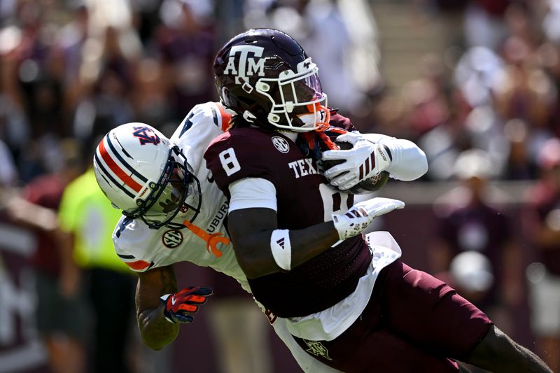 Sep 27, 2025; College Station, Texas, USA; Texas A&M Aggies running back Le'Veon Moss (8) is tackled by Auburn Tigers cornerback Kayin Lee (4) during the first quarter at Kyle Field. Mandatory Credit: Maria Lysaker-Imagn Images