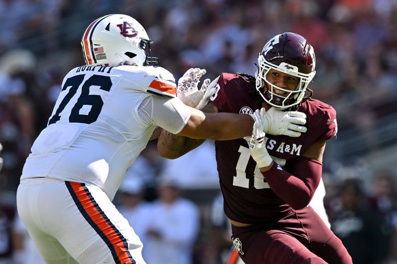 Sep 27, 2025; College Station, Texas, USA; Texas A&M Aggies defensive end T.J. Searcy (18) defends in coverage as Auburn Tigers offensive lineman Mason Murphy (76) attempts to block during the second quarter at Kyle Field. Mandatory Credit: Maria Lysaker-Imagn Images