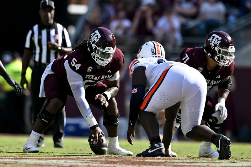 Sep 27, 2025; College Station, Texas, USA; Texas A&M Aggies offensive lineman Mark Nabou Jr. (54) sets the ball during the first half against the Auburn Tigers at Kyle Field. Mandatory Credit: Maria Lysaker-Imagn Images