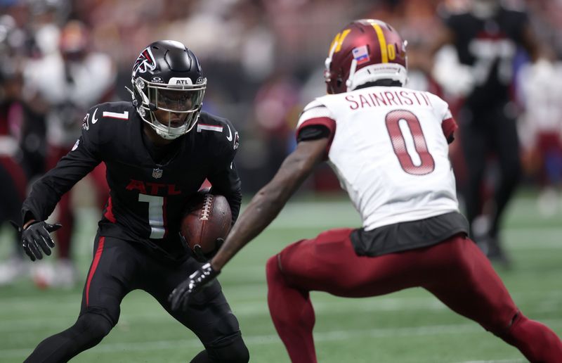 Sep 28, 2025; Atlanta, Georgia, USA; Atlanta Falcons wide receiver Darnell Mooney (1) runs against Washington Commanders cornerback Mike Sainristil (0) during the first half at Mercedes-Benz Stadium. Mandatory Credit: Brett Davis-Imagn Images