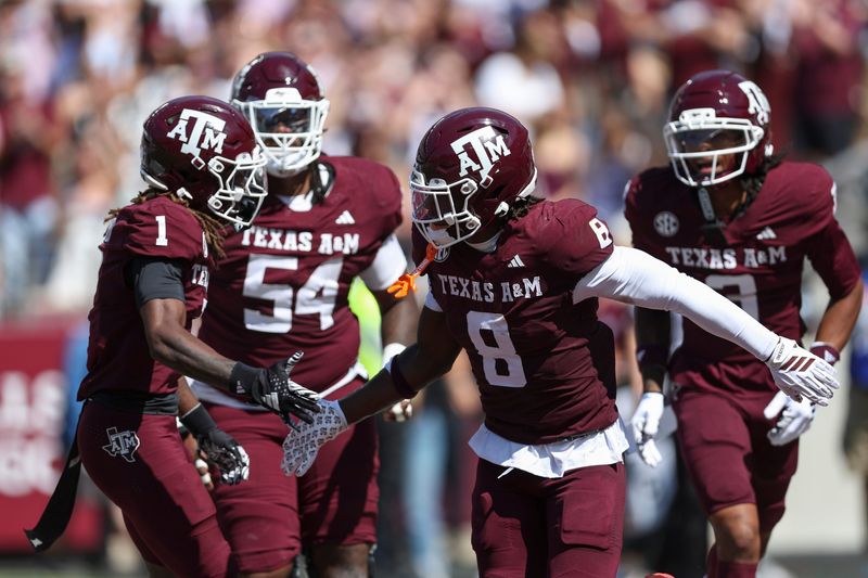 Sep 27, 2025; College Station, Texas, USA; Texas A&M Aggies running back Le'Veon Moss (8) celebrats with wide receiver Mario Craver (1) after a touchdown during the first quarter against the Auburn Tigers at Kyle Field. Mandatory Credit: Troy Taormina-Imagn Images