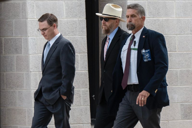 At left, Adam Kincaid, executive director of the National Republican Redistricting Trust and a witness for the state of Texas, arrives at the Albert Armendariz Sr. U.S. Courthouse in Downtown El Paso, Texas, on Monday, Oct. 7, 2025, to testify in a federal redistricting lawsuit. The case, brought by civil rights groups, challenges the constitutionality of Texas’ newly drawn congressional maps, alleging they dilute the voting power of Black and Hispanic communities.