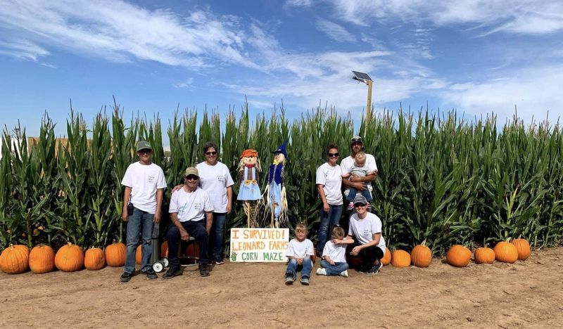 A previous group at Leonard Farms poses by a sign, telling that they survived the haunted corn maze, which is a huge draw for the family-owned farm six miles west of Canyon.