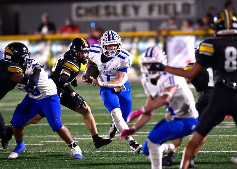Stamford quarterback Mason Mueller scrambles with the ball as Cisco linebacker Kreed Gorr closes in behind him during Friday’s game in Cisco Oct. 10, 2025. Final score was 30-20, Cisco.